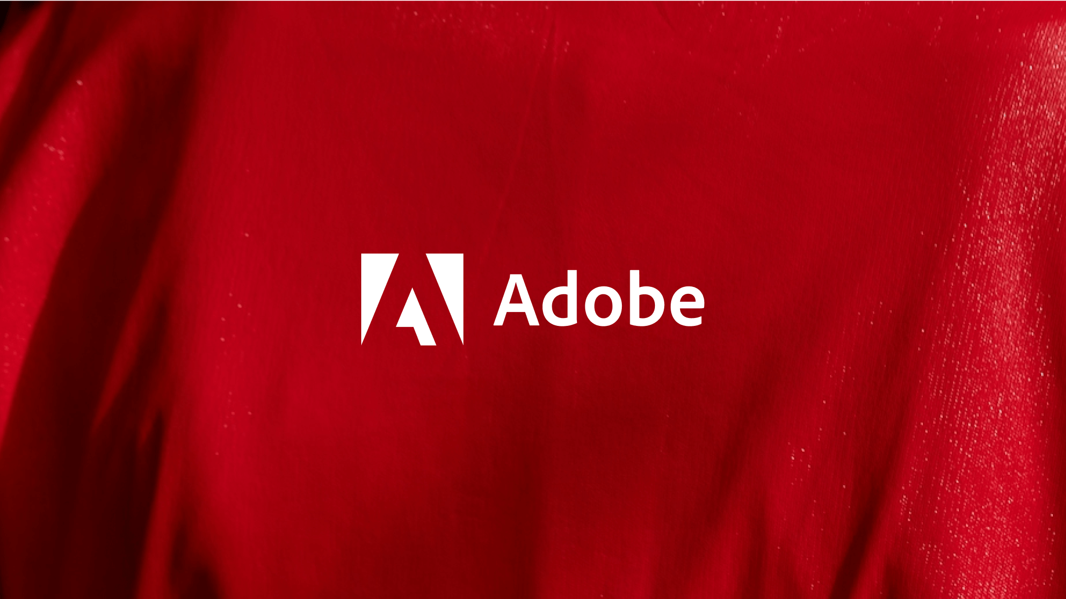 White Adobe logo on a red background